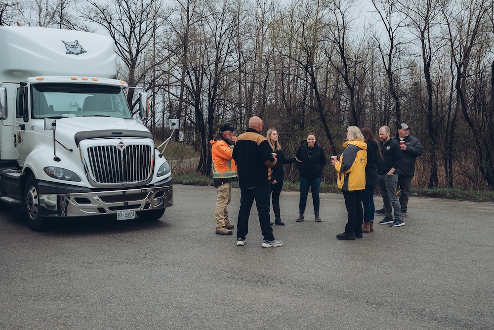 KnowledgeSurge-outside-training A KnowledgeSurge class gathered around a vehicle part.
